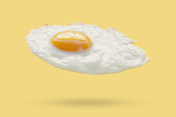 Fried egg float on yellow background