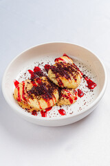 Enjoying a luscious dessert with creamy layers topped with vibrant sauces and fine sprinkles
