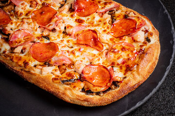 Melted cheese and savory toppings create an appetizing view of a freshly baked pizza ready to enjoy