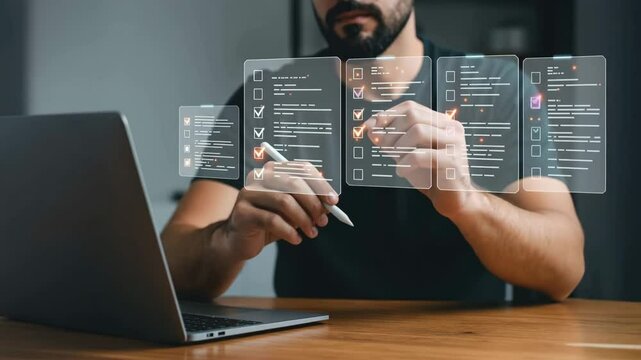 A focused young adult male with a beard actively engaging with a laptop and digital task list in a modern workspace, illustrating productivity and tech integration in daily routines.