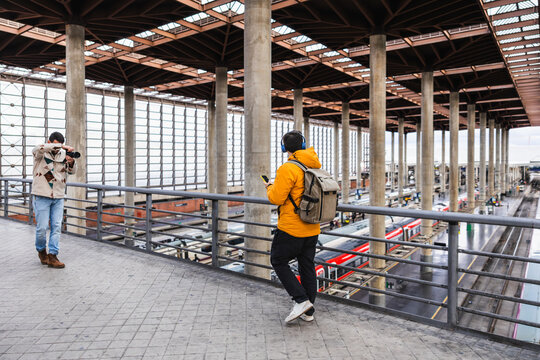 Content creators filming travel report at atocha train station, madrid