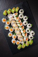 An artistic presentation of assorted sushi rolls highlights rich flavors and fresh ingredients