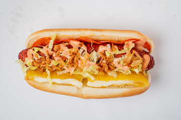 Gourmet hot dog with crispy toppings and vibrant sauces for a tasty experience