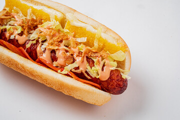 Tasty hot dog loaded with vibrant toppings, served during a bustling lunchtime in a food market