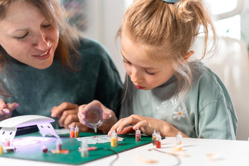 Creating handmade resin jewelry with colorful glitter. Detailed process involves pouring, setting, polishing resin pieces, making elegant and unique accessories for fashion enthusiasts and children.