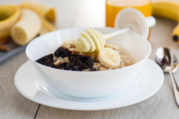 Healthy and nutritious breakfast with oatmeal and honey