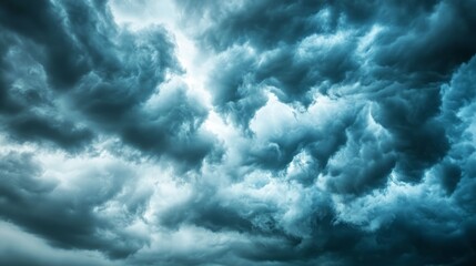 Obraz premium Storm clouds loom over the prairie, a vast sky in moody blues and greys, evoking nature's raw power and solitude. 