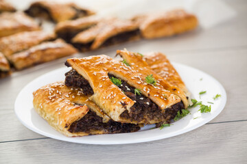 Golden puff pastries with mushroom filling and sesame seeds