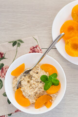Healthy and balanced breakfast with oatmeal and fruits