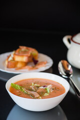 Dietary fish soup-puree with salmon, isolated on black background