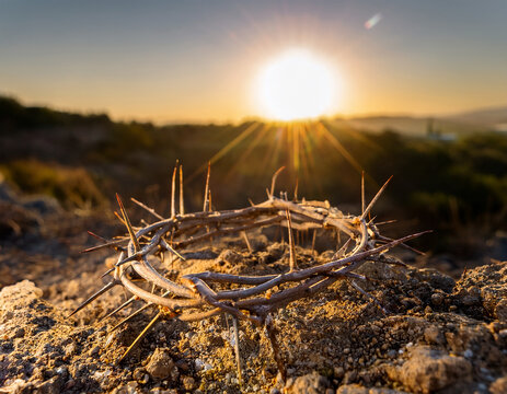 Crown of thorns on rocky ground at sunset. Good Friday. Christian holy day. Sacrifice, pain