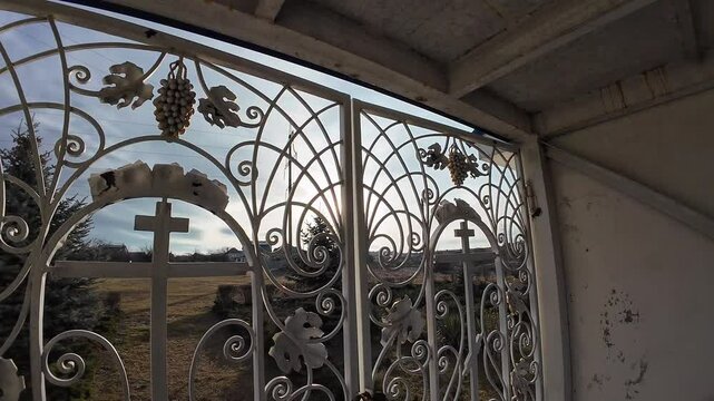 beautiful forged gates. Beautiful view of an old city architecture with stone stairs, columns, stucco moulding, plaster of paris. Grandiose forged gates, church gates.