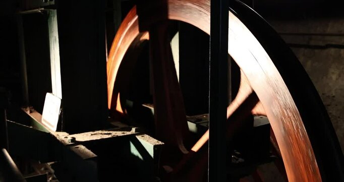 wooden gear wheel turning to pull steel cable