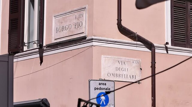 A charming Roman street corner where Borgo Pio meets Via degli Ombrellari, framed by historic buildings in the Vatican surroundings
