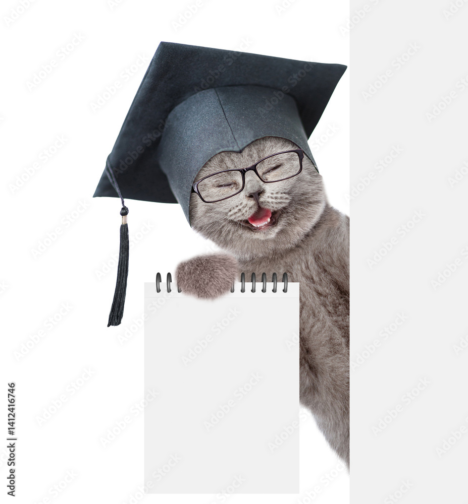 Leinwandbilder сollege graduate kitten holds blank list in it paw and looks from behind blank white banner. empty s