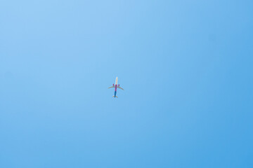 airplane in flight in a clear blue sky 
