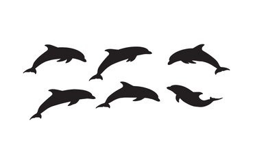 Fototapeta premium Graceful silhouettes of dolphins diving in blue waters