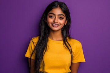Fototapeta premium A studio portrait captures an Indian woman with her long hair flying out to the sides as she poses