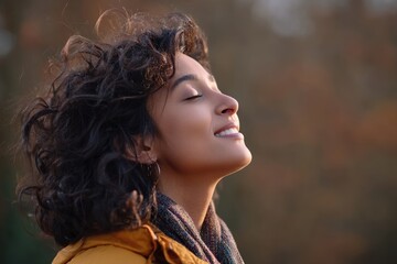 While looking upwards, a latin woman is calm as she breathes in and enjoys the autumn atmosphere