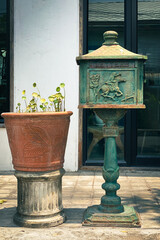 Vintage Decorative Mailbox and Succulent Planter in Garden Setting
