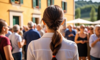 Fototapeta premium Woman observing lively outdoor gathering at summer event