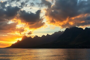 Serene Sunset Over Majestic Mountains and Calm Ocean Waters