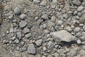 Crushed grey stones and sand background, flat lay or top view