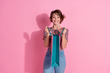 Photo of glad cheerful lovely cute girl wear print stylish clothes open bag look inside isolated on pink color background