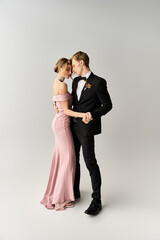 Young couple celebrating their spring wedding in elegant attire and joyful embrace