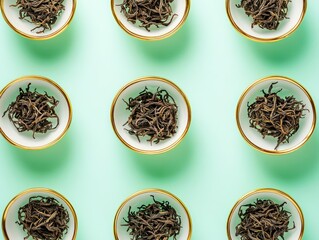 Fototapeta premium A top-down symmetrical featuring tea leaves in delicate golden-rimmed bowls, arranged in a radial pattern for an elegant and luxurious presentation