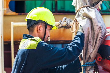 Portrait of the young Filipino officer, fully focused on his task during the inspection of the...