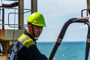 Portrait of the young Filipino officer, fully focused on his task during the inspection of the...