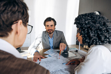 Architect explaining project to clients during a meeting