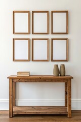 Fototapeta premium Wooden console table with empty frames on a wall, stylish decor., Sustainable Furniture concept