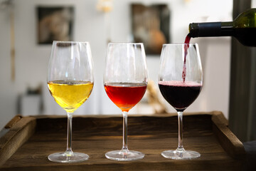 three glasses of Italian wine in different colors white rosé and red