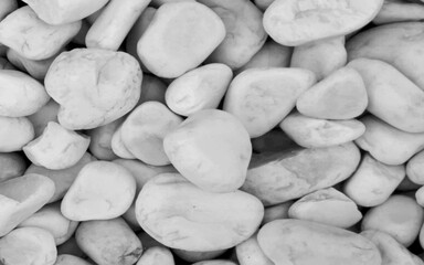 Dramatic stone wall background texture. White pebbles background. White stones on a black background