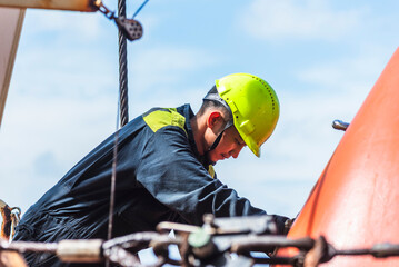 Portrait of the young Filipino officer, fully focused on his task during the inspection of the...