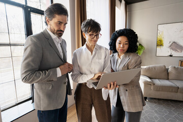 Business team working together using laptop in modern office