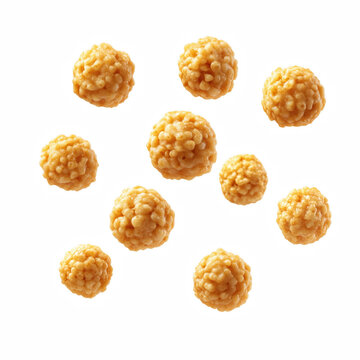 Floating crispy corn cereal balls with golden texture and crunchy surface isolated on transparent background.