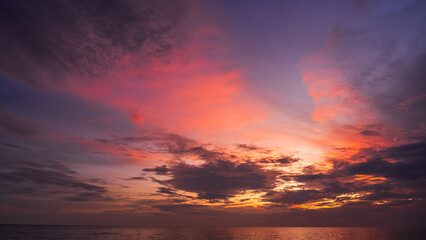 Dusk, Sunset sky clouds over sea in the evening on twilight with Blue, Purple, Pink and Orange sunlight, Horizon sea sky landscape backgrounds in Summer