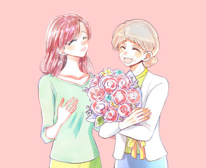 年配の女性に花束を贈る女性