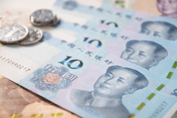 Many of different Chinese yuan banknotes. Chinese paper currency Yuan renminbi banknotes and coins as background.