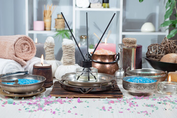 Spa treatment with candles and towel on wooden table, close up