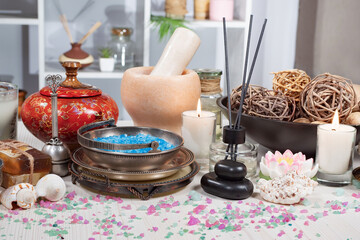 Spa items are arranged in a composition on a table.