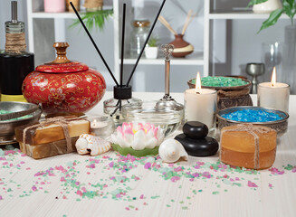 Spa items are arranged in a composition on a table.