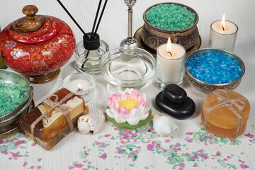 Spa items are arranged in a composition on a table.