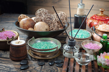 Spa treatment with candles and towel on wooden table, closeup