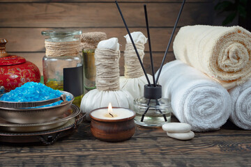 Spa items are arranged in a composition on a table.