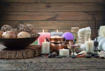 Spa treatment with candles and towel on wooden table, closeup