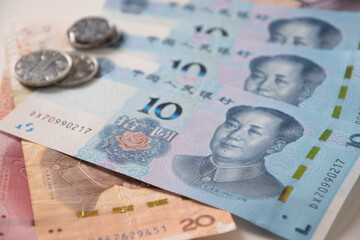 Many of different Chinese yuan banknotes. Chinese paper currency Yuan renminbi banknotes and coins as background.